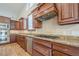Modern kitchen with granite counters, tile backsplash and stainless appliances at 10280 Medridge Cir, Johns Creek, GA 30022