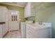 Functional laundry room with ample cabinet space, utility sink, washer, and dryer hookups at 10280 Medridge Cir, Johns Creek, GA 30022