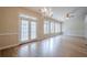 Bright living room with hardwood floors, chandelier, windows and patio doors at 10280 Medridge Cir, Johns Creek, GA 30022