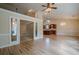 Open-concept living room with hardwood floors and adjacent kitchen at 10280 Medridge Cir, Johns Creek, GA 30022