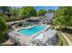 Aerial view of the community pool with slide, lounge chairs, and tables at 10280 Medridge Cir, Johns Creek, GA 30022