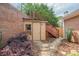 Backyard shed with brick wall, wood door, and staircase to the main level at 10280 Medridge Cir, Johns Creek, GA 30022