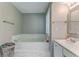 Bathroom with a marble-tiled tub and single vanity and sink at 3288 Owens Meadow Ln, Kennesaw, GA 30152