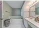 Bathroom with a marble-tiled tub and single vanity and sink at 3288 Owens Meadow Ln, Kennesaw, GA 30152
