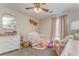 Brightly decorated Bedroom with crib, dresser, and soft pink accents at 3288 Owens Meadow Ln, Kennesaw, GA 30152