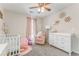 Cozy Bedroom with pink accents, includes a crib, changing table, and comfortable rocking chair at 3288 Owens Meadow Ln, Kennesaw, GA 30152