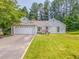 Charming single-story home featuring a well-maintained lawn and an attached two-car garage at 3288 Owens Meadow Ln, Kennesaw, GA 30152