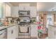 Well-lit kitchen with stainless steel appliances and white cabinets, perfect for cooking and entertaining at 3288 Owens Meadow Ln, Kennesaw, GA 30152