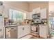 Bright kitchen features white cabinets, stainless steel appliances, and ample counter space at 3288 Owens Meadow Ln, Kennesaw, GA 30152