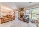 Cozy living room with a stone fireplace, natural light, and comfortable seating at 3288 Owens Meadow Ln, Kennesaw, GA 30152