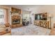 Comfortable living room features a stone fireplace, TV and bright natural light at 3288 Owens Meadow Ln, Kennesaw, GA 30152
