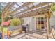 Patio with wooden pergola, grill, and bench seating, perfect for outdoor dining and entertaining at 3288 Owens Meadow Ln, Kennesaw, GA 30152