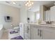 Well-lit bathroom with dual sinks, white cabinetry, and modern fixtures at 5880 Garden Circle Cir, Douglasville, GA 30135
