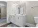 Bright bathroom featuring white cabinets, double sinks, and a large mirror at 5880 Garden Circle Cir, Douglasville, GA 30135