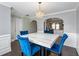 Dining room features hardwood floors, white marble table with blue chairs, and stainless steel appliances at 5880 Garden Circle Cir, Douglasville, GA 30135