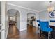 Modern dining room with hardwood floors, arched entryway, and stylish chandelier at 5880 Garden Circle Cir, Douglasville, GA 30135