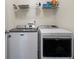 Convenient laundry area with modern washer and dryer units and wire shelving at 5880 Garden Circle Cir, Douglasville, GA 30135