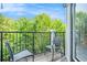 Relaxing balcony with chairs and a view of lush greenery and blue sky at 898 Oak Sw St # 3420, Atlanta, GA 30310