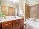Bright bathroom with tub, tile surround, dark cabinets, and decor at 898 Oak Sw St # 3420, Atlanta, GA 30310