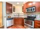 Well-equipped kitchen boasts stainless steel appliances, granite counters, and sleek dark wood cabinetry at 898 Oak Sw St # 3420, Atlanta, GA 30310