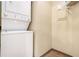 Convenient laundry room with stacked washer and dryer and built-in shelving at 898 Oak Sw St # 3420, Atlanta, GA 30310