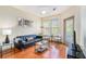 Bright living room boasts hardwood floors, modern furnishings, and natural light from large windows at 898 Oak Sw St # 3420, Atlanta, GA 30310