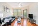 Bright living room with hardwood floors, black leather sofa, and abundant natural light at 898 Oak Sw St # 3420, Atlanta, GA 30310