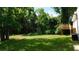 Expansive backyard featuring lush greenery, a wooden deck, and a serene, private setting at 9148 Homewood Dr, Riverdale, GA 30274