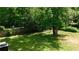 Spacious backyard with mature trees, a wooden fence, and a cooling AC unit at 9148 Homewood Dr, Riverdale, GA 30274