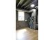 Finished basement with painted concrete walls and exposed piping at 9148 Homewood Dr, Riverdale, GA 30274