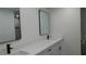 Bathroom featuring dual sink vanity, white quartz countertops, and dark hardware at 9148 Homewood Dr, Riverdale, GA 30274