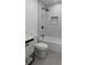 Sleek bathroom with modern vanity, bathtub, black hardware, and marble-look tile at 9148 Homewood Dr, Riverdale, GA 30274