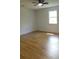 Bedroom features hardwood floors, neutral paint, and natural light from the window at 9148 Homewood Dr, Riverdale, GA 30274