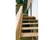 Side view of a wooden deck and railing alongside a white house with a black door at 9148 Homewood Dr, Riverdale, GA 30274
