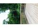 A wooden deck with a railing overlooks lush greenery, creating a private outdoor space at 9148 Homewood Dr, Riverdale, GA 30274