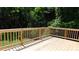 A spacious wood deck with a wooden railing overlooking a lush green backyard at 9148 Homewood Dr, Riverdale, GA 30274