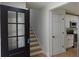 Entryway featuring hardwood floors, stairs, and views of the updated kitchen at 9148 Homewood Dr, Riverdale, GA 30274