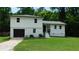 Charming two-story home features a fresh exterior paint, attached garage, and well-maintained front lawn at 9148 Homewood Dr, Riverdale, GA 30274