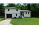 Charming two-story home features a fresh exterior paint, attached garage, and well-maintained front lawn at 9148 Homewood Dr, Riverdale, GA 30274