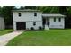 Charming two-story home features a fresh exterior paint, attached garage, and well-maintained front lawn at 9148 Homewood Dr, Riverdale, GA 30274