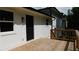 Rear exterior of a house featuring a wooden deck, dark windows and a white facade at 9148 Homewood Dr, Riverdale, GA 30274