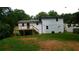 Rear view of a home featuring a wooden deck, white siding, and a spacious backyard at 9148 Homewood Dr, Riverdale, GA 30274