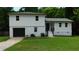 Charming two-story home features a fresh exterior paint, attached garage, and well-maintained front lawn at 9148 Homewood Dr, Riverdale, GA 30274