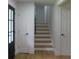 Hallway with staircase, wood floors, fresh paint and neutral finishes throughout at 9148 Homewood Dr, Riverdale, GA 30274