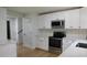 Modern kitchen features stainless steel appliances, white cabinets, quartz countertops, and subway tile backsplash at 9148 Homewood Dr, Riverdale, GA 30274