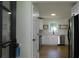 Bright kitchen featuring hardwood floors, white cabinets, and stainless steel appliances at 9148 Homewood Dr, Riverdale, GA 30274