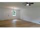 Bright living room featuring hardwood floors, a modern light fixture, and fresh, neutral paint at 9148 Homewood Dr, Riverdale, GA 30274