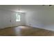 Bright living room featuring hardwood floors, a modern light fixture, and fresh, neutral paint at 9148 Homewood Dr, Riverdale, GA 30274