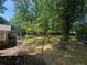 Fenced backyard featuring mature trees providing plenty of shade at 1268 Woodland Ne Rd, Conyers, GA 30012