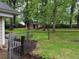 Large backyard with metal chain fence and a storage shed behind the trees at 1268 Woodland Ne Rd, Conyers, GA 30012